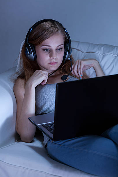 istock Girl talking online on couch 522035629