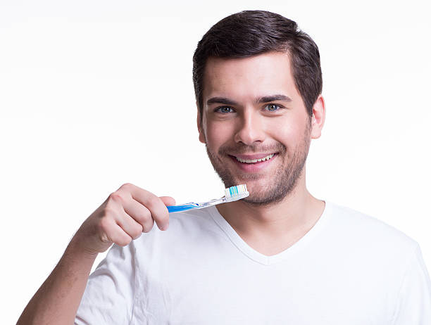istock Smiling young man with a toothbrush. 522035755