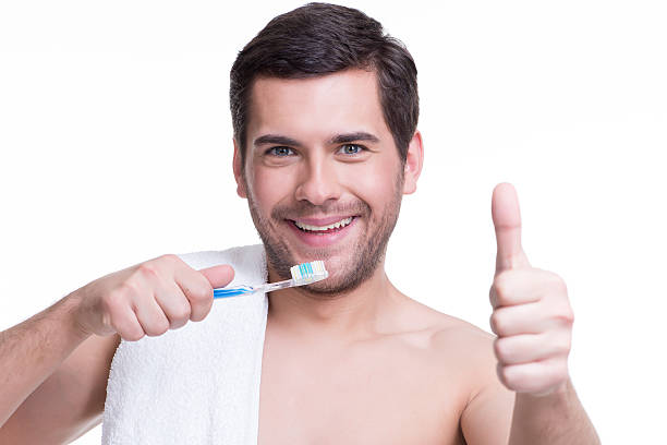 istock Smiling young man with a toothbrush. 522035919