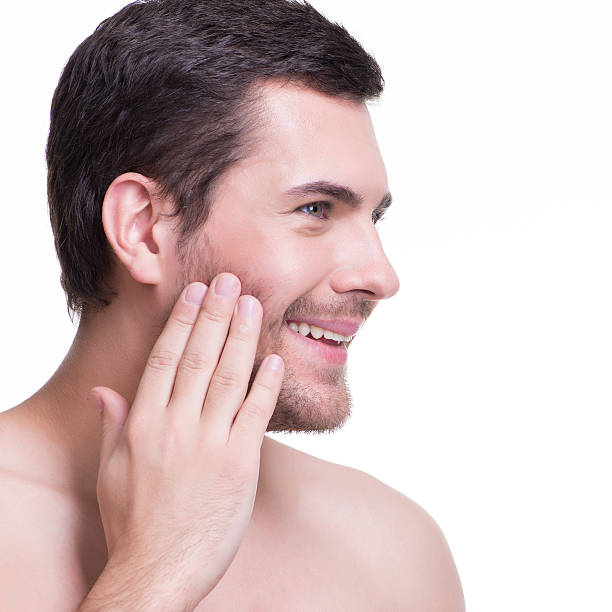 istock Smiling young man with hand near the face. 522036417