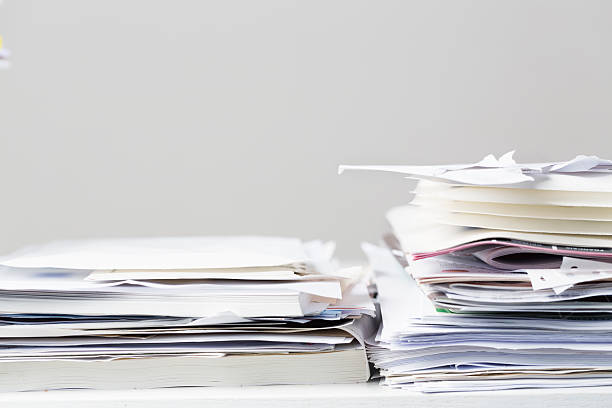 istock messy stacks of office papers 522051565