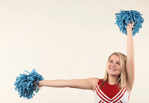 Stock photo of a fifteen year old cheerleader isolated on a white background.