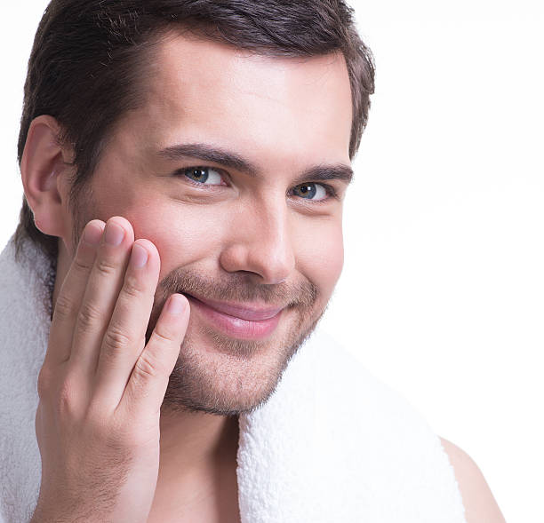 istock Smiling young man with hand near the face. 522052877