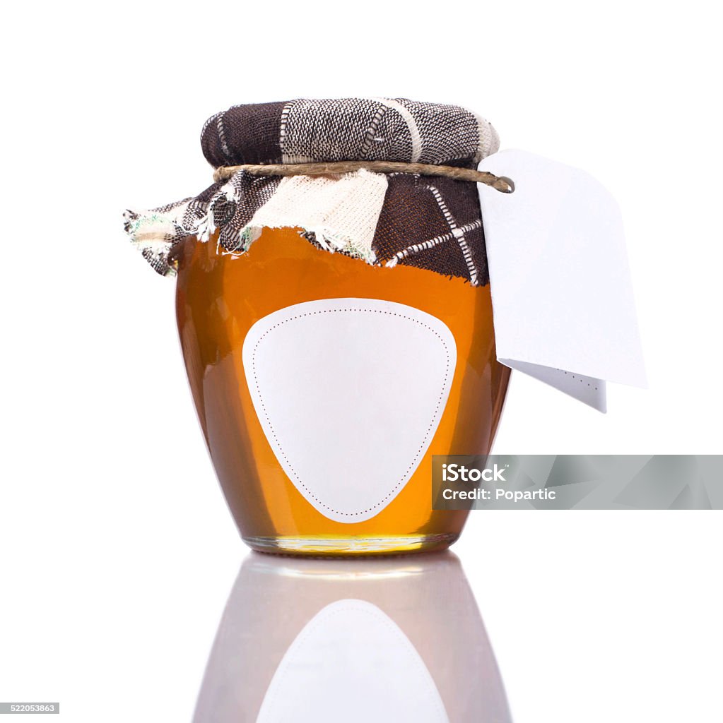 Honey jar with blank label and etiquette Honey jar with blank label and etiquette on white background. Blank Stock Photo