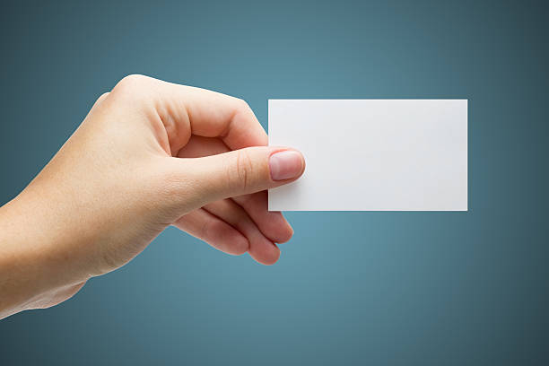 istock Hand holds a white business card on a blue background 522055223