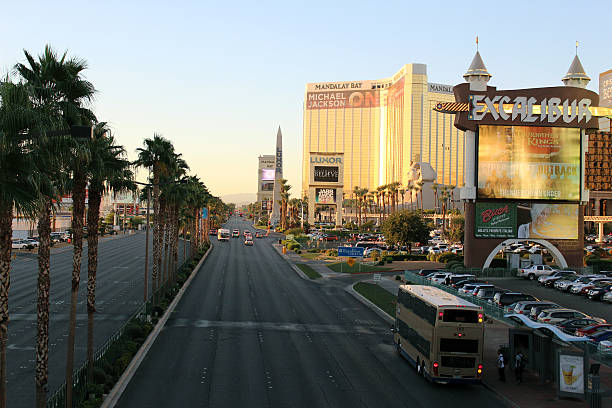 Las Vegas Boulevard Las Vegas, NV, USA - October 22, 2014: Las Vegas Boulevard illuminated at sunrise. Las Vegas Boulevard is also known as The Strip. Featured Mandalay Bay Hotel and Excalibur Hotel street signage. luxor las vegas stock pictures, royalty-free photos & images