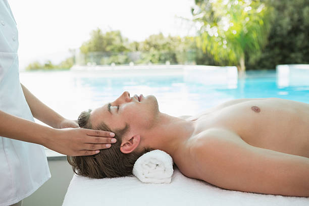 istock Handsome man receiving head massage at spa center 522074561