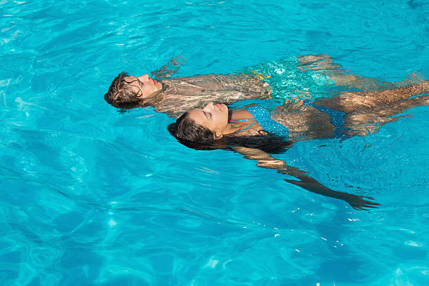 istock Relaxed young couple in swimming pool 522077237
