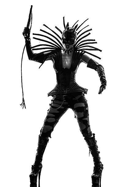 woman in catwoman leather latex fetish wear silhouette one woman in catwoman leather latex with whip in silhouette studio isolated on white background Tied Up Bondage Women Fetish Wear stock pictures, royalty-free photos & images