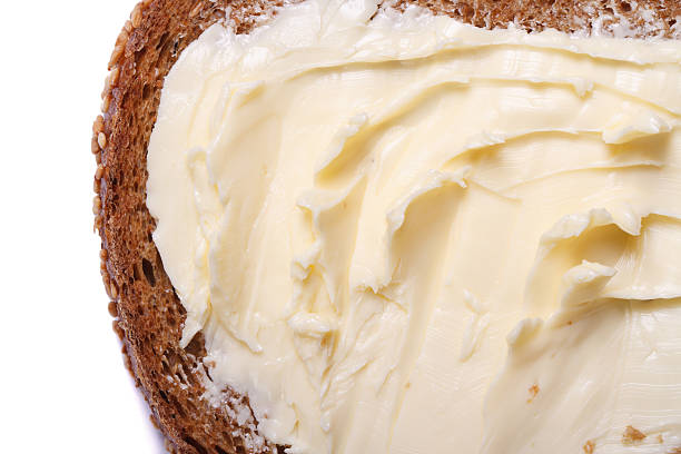 istock bread with butter close up isolated on white background. macro 522077411