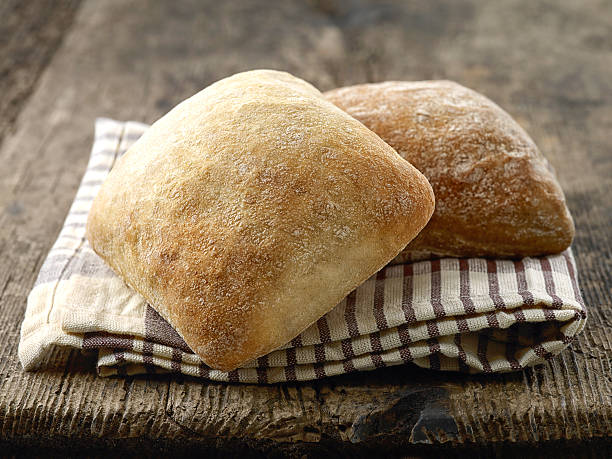 two ciabatta bread buns two ciabatta bread buns on wooden table ciabatta stock pictures, royalty-free photos & images