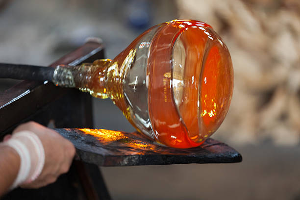 istock glass blower carefully making his product 522077865