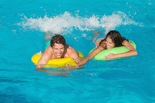istock Couple in inflatable rings at swimming pool 522080985