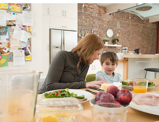 istock Son And Mother Having Meal At Dining Table In Kitchen 522081551