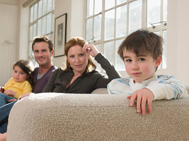 istock Cute Boy With Family Sitting On Sofa 522098757