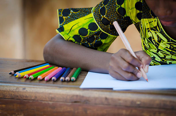 istock Writing Activity - Black Girl Drawing On Desk 522113541