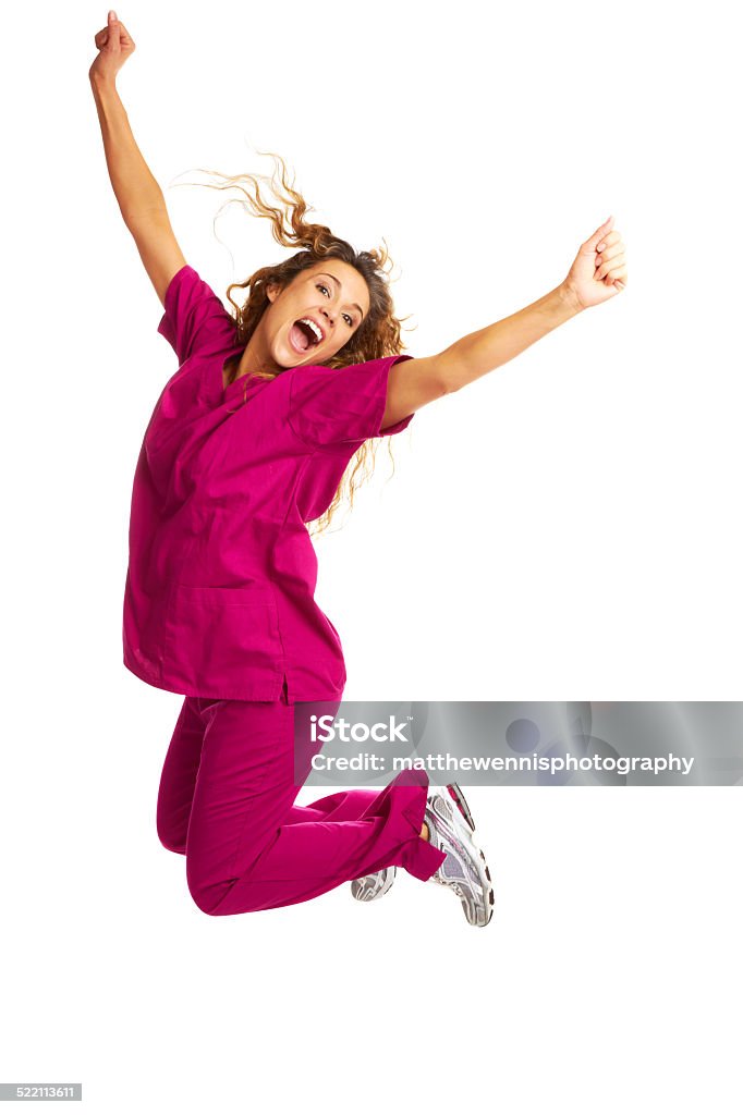 Smiling Female Nurse Throwing Apple Over White Background Portrait of smiling young female nurse throwing apple over white background Nurse Stock Photo