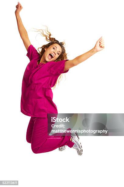 Smiling Female Nurse Throwing Apple Over White Background Stock Photo - Download Image Now