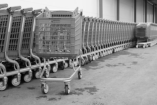 istock black-white baskets-carts on wheels for goods 522114461