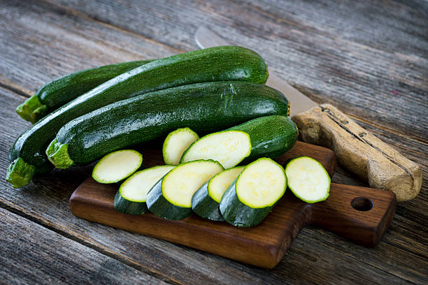 istock Fresh zucchini on wooden background 522123930