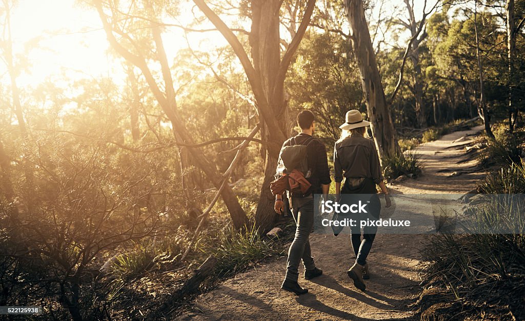 Spending a weekend in the wilderness Shot of a couple going for a walk on a nature trail Walking Stock Photo