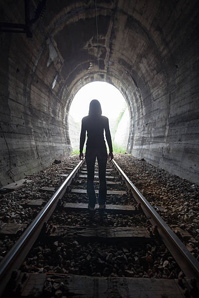 istock Man in a tunnel looking towards the light 522126132