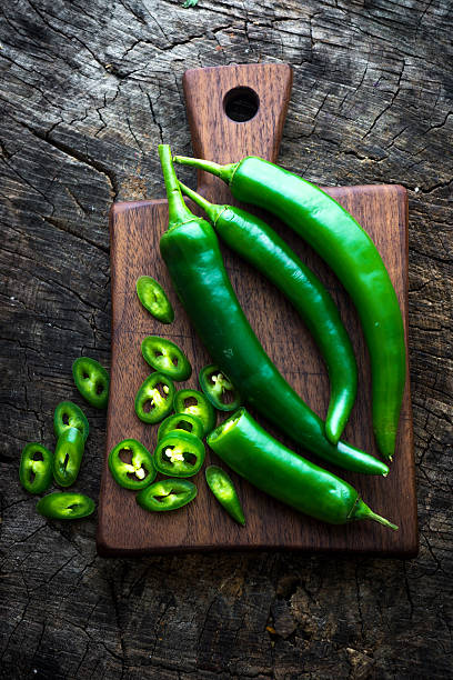 istock Fresh green chilli on old wooden background 522126212