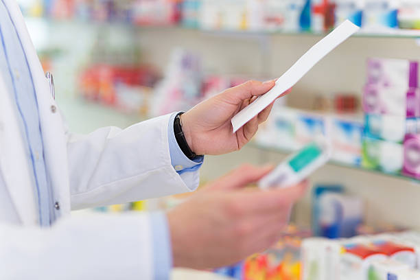 Pharmacist searching the right medicine stock photo