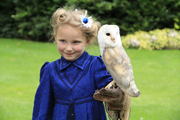 istock Cheecky girl with owl 522128027