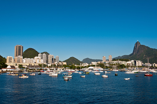 Scenic View of Rio de Janeiro City and Corcovado Mountain with Christ the Redeemer, Boats in the Harbor and Hills.
