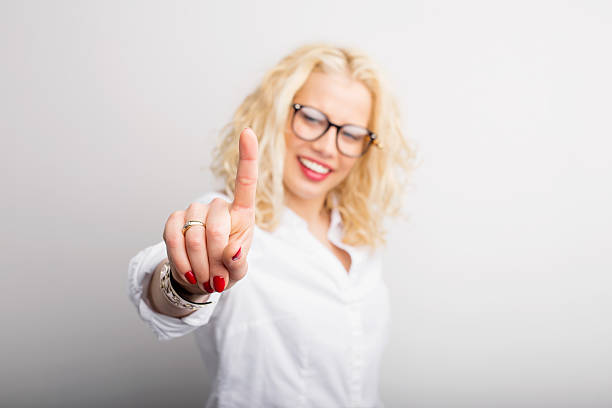 Woman showing that she is  pressing something with finger