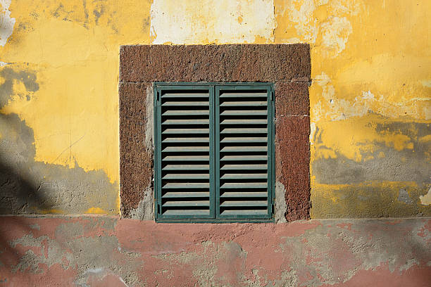 istock Shutters in weathered wall. Funchal, Madeira 522129930