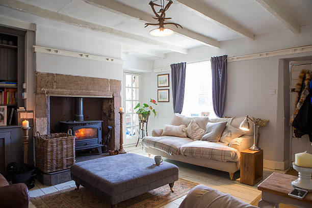 Home Living Room A beautiful photo of a cosy living room fireplace and armchair stock pictures, royalty-free photos & images