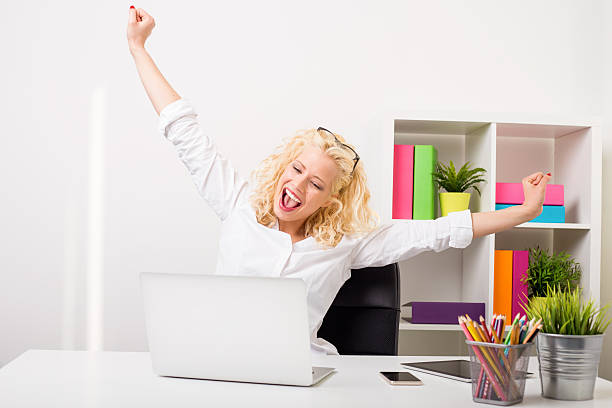 istock Business woman at the office celebrating with both hands up 522130498