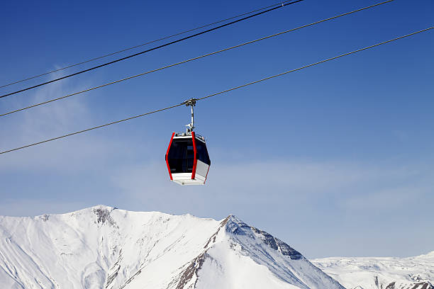 istock Gondola lift and snowy mountains 522130965