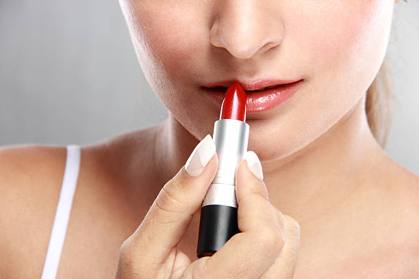 istock beautiful caucasian model applying lipstick 522132400