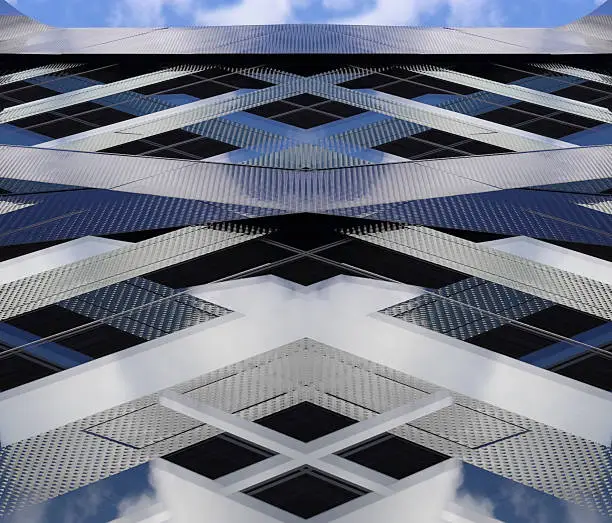 Double exposure photo of real modern building fragment against sunny sky with clouds gave this unreal hi-tech architectural composition.