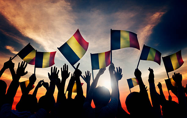 istock Group of People Waving Belgian Flags in Back Lit 522134021