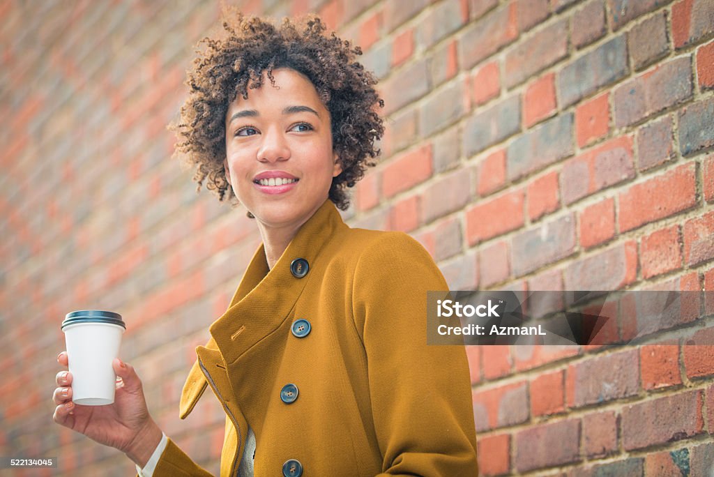 Woman with coffee Beautiful woman with coffe, waiting outdoors. Brick Stock Photo