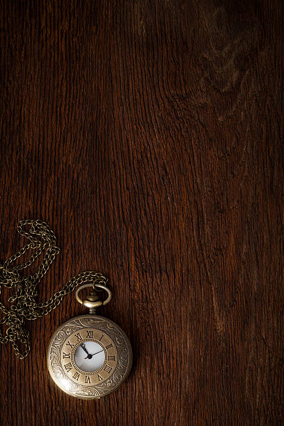 istock Vintage pocket watches on dark oak texture background 522134333