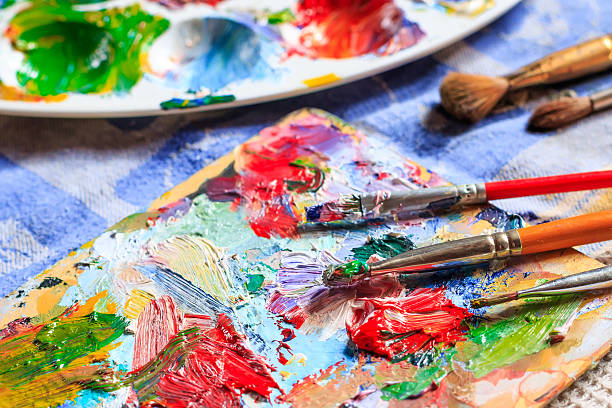 istock Colourful oil paint, different types of brushes and palette 522134888