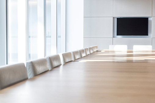 Empty corporate business board room meeting room in modern office block.
