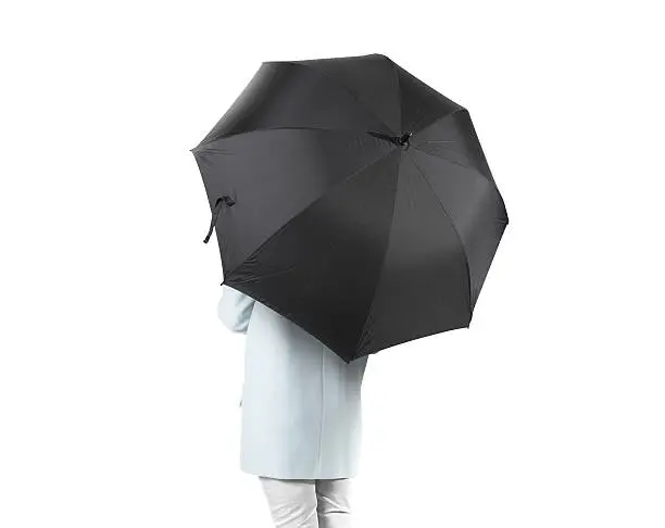 Photo of Women stand backwards with black blank umbrella opened mockup isolated