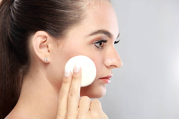 istock beautiful young model holding a powder puff 522140400