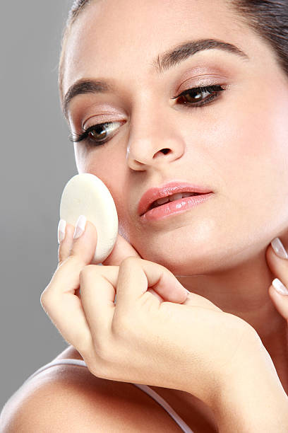 istock beautiful caucasian model applying some powder 522140674