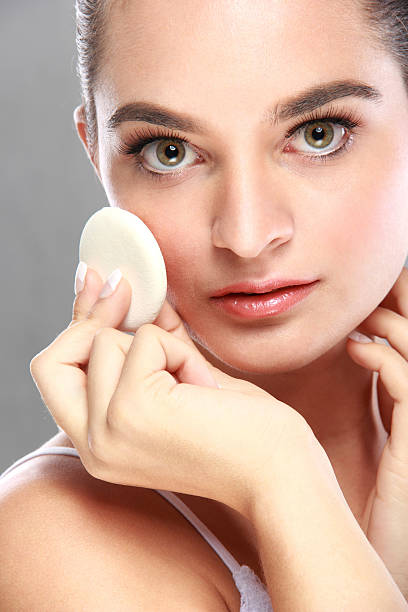 istock beautiful caucasian model applying some powder 522140910