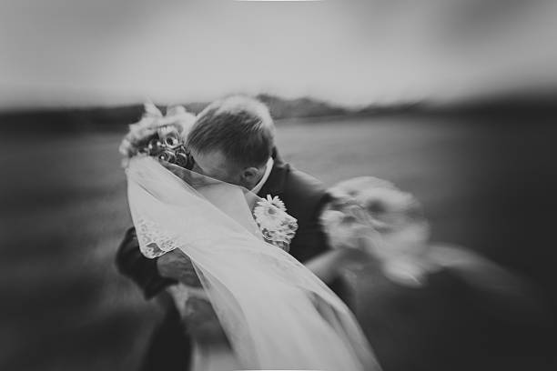 istock Kissing wedding couple in high grass 522140926