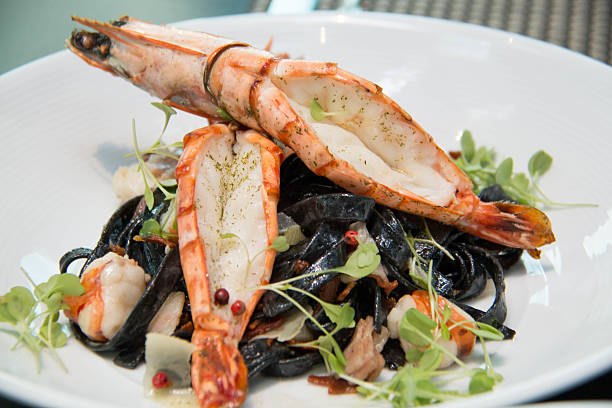istock Black squid ink pasta is paired with scallops on pasta 522141628