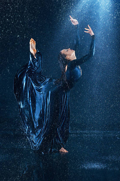 istock The young beautiful modern dancer dancing under water drops 522142276