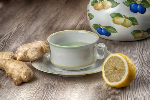 Ginger tea with lemon on a wooden table
